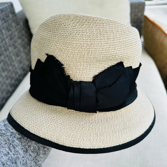 Albertus Swanepoel fedora. Natural raffia w/ shiny thread. Black satin band/bow. Women